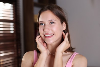 Photo of Portrait of smiling teenage girl at home