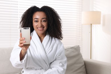 Photo of Beautiful Brazilian woman with glass of collagen water indoors