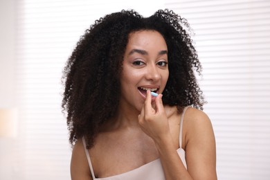 Photo of Beautiful Brazilian woman with collagen pill indoors