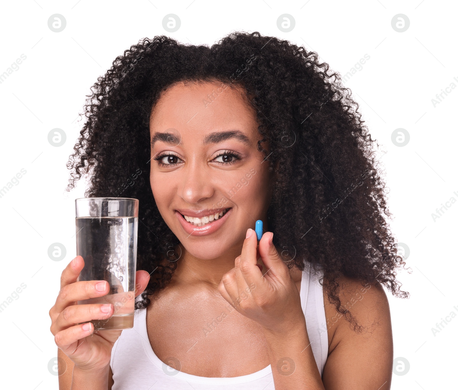 Beautiful Brazilian woman with glass of water and collagen pill on white background Photo of Beautiful Brazilian woman with glass of water and collagen pill on white background