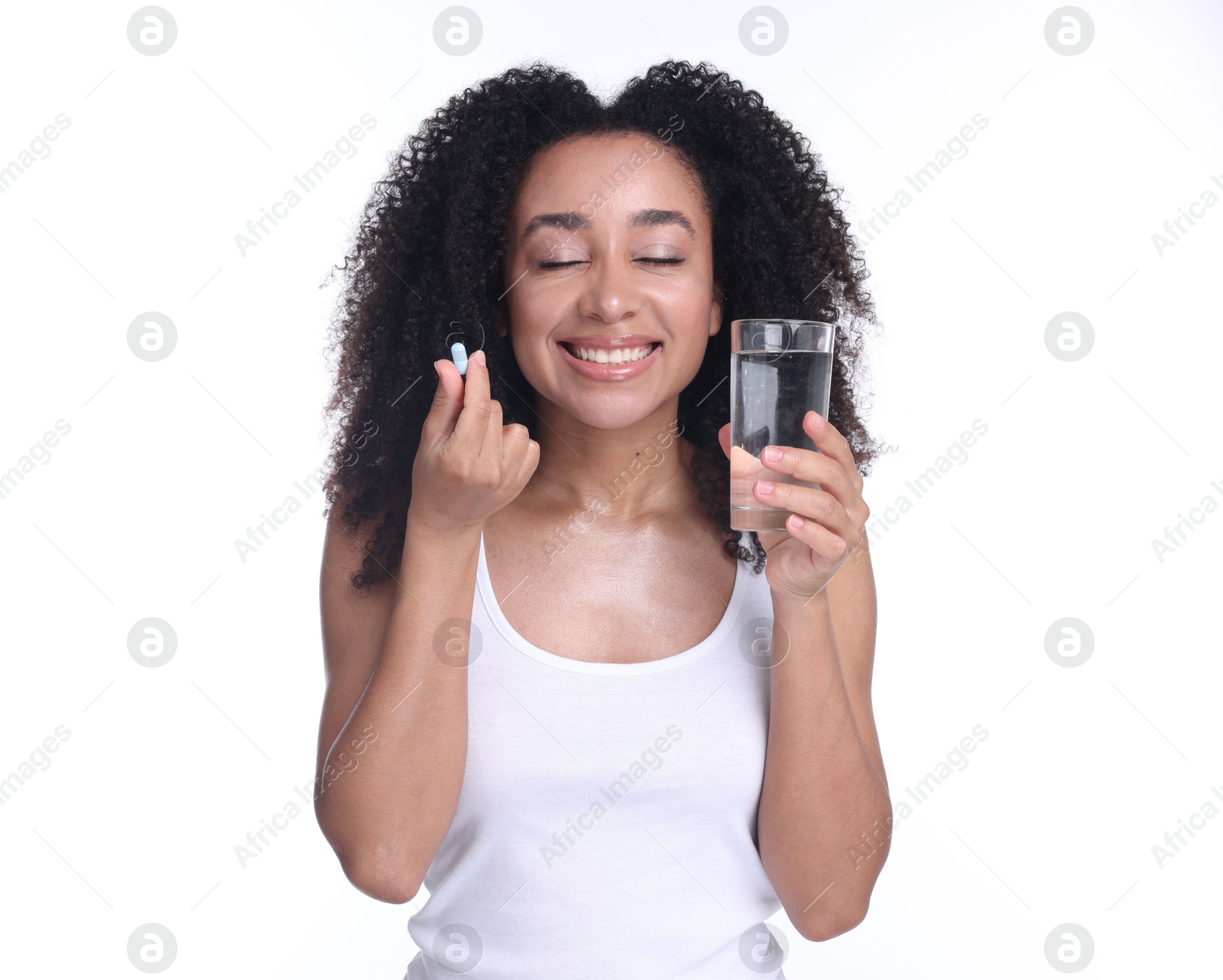 Beautiful Brazilian woman with glass of water and collagen pill on white background Photo of Beautiful Brazilian woman with glass of water and collagen pill on white background
