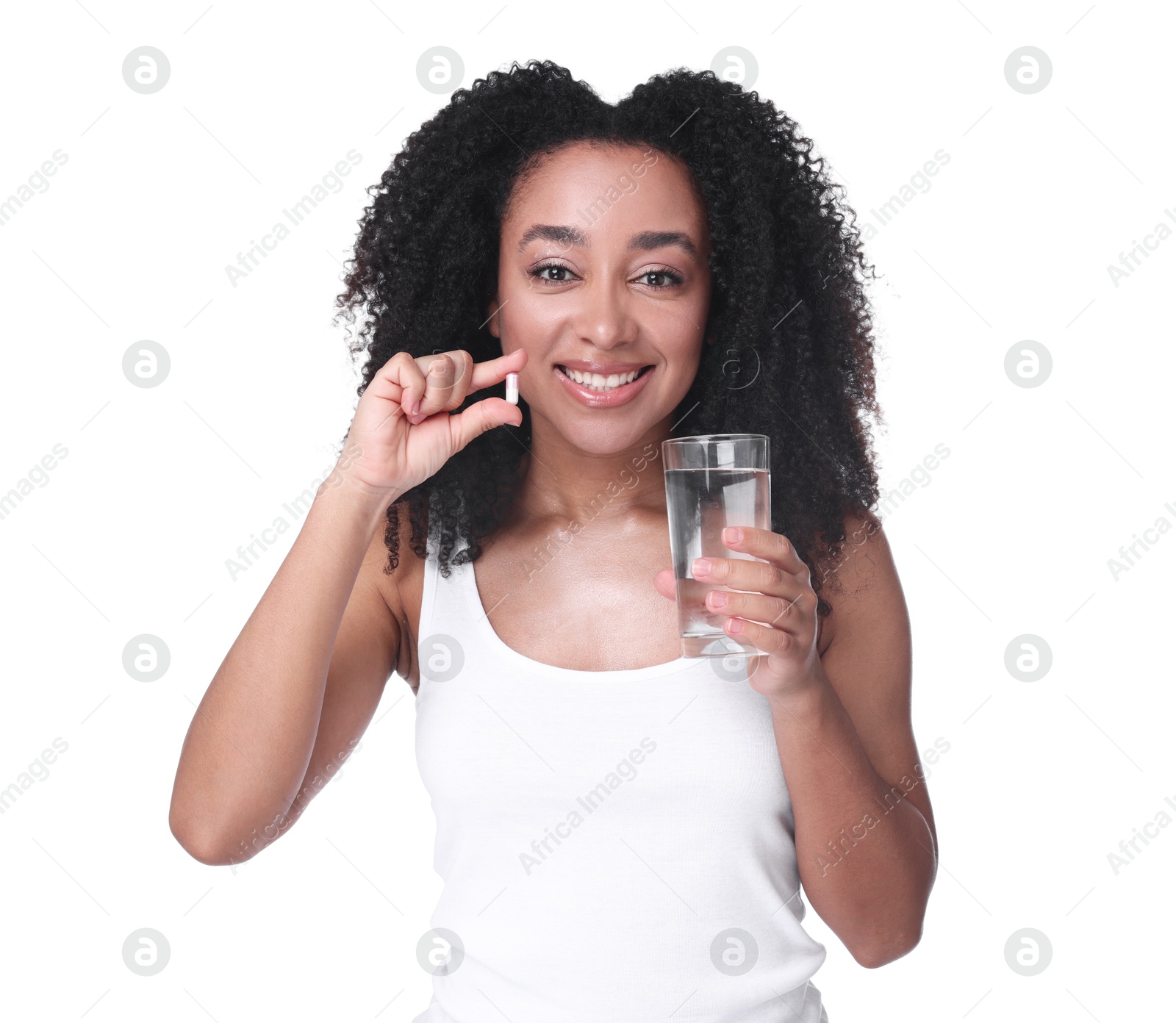 Beautiful Brazilian woman with glass of water and collagen pill on white background Photo of Beautiful Brazilian woman with glass of water and collagen pill on white background