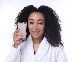 Photo of Beautiful Brazilian woman with glass of collagen water on white background