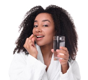 Photo of Beautiful Brazilian woman with glass of water and collagen pill on white background