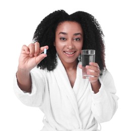 Photo of Beautiful Brazilian woman with glass of water and collagen pill on white background