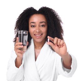 Photo of Beautiful Brazilian woman with glass of water and collagen pill on white background