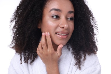 Photo of Beautiful Brazilian woman applying collagen cream on white background