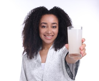 Photo of Beautiful Brazilian woman with glass of collagen water on white background, selective focus