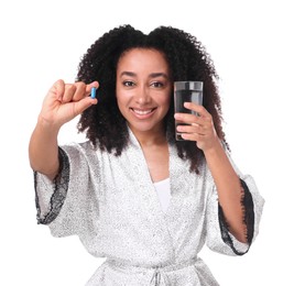 Photo of Beautiful Brazilian woman with glass of water and collagen pill on white background