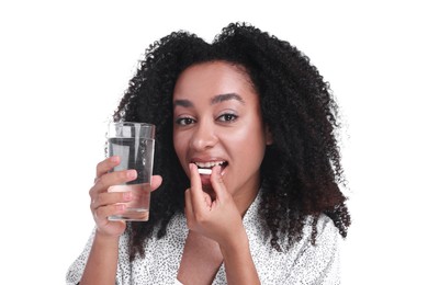 Photo of Beautiful Brazilian woman with glass of water and collagen pill on white background