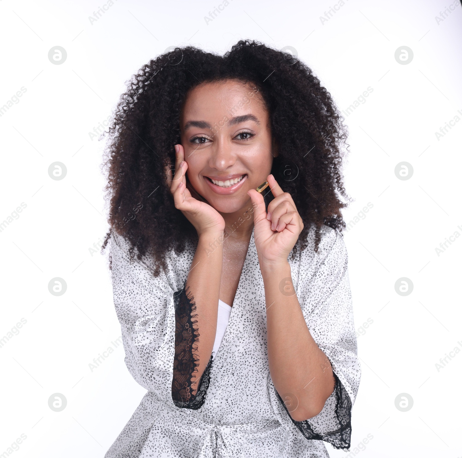 Beautiful Brazilian woman with collagen pill on white background Photo of Beautiful Brazilian woman with collagen pill on white background