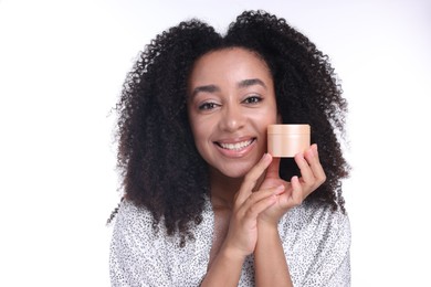 Photo of Beautiful Brazilian woman with jar of collagen cream on white background