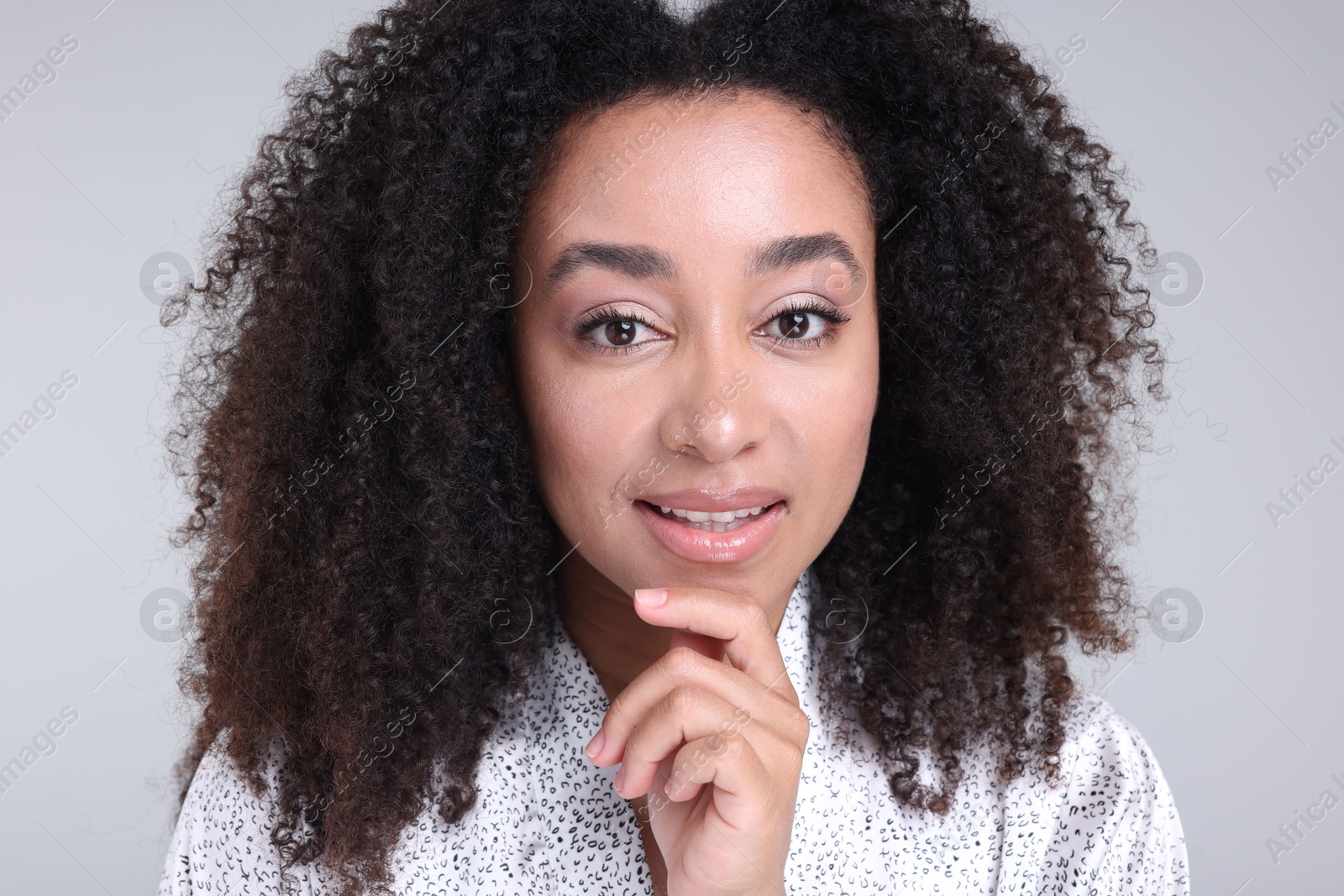 Beautiful Brazilian woman with healthy skin on gray background, closeup Photo of Beautiful Brazilian woman with healthy skin on gray background, closeup