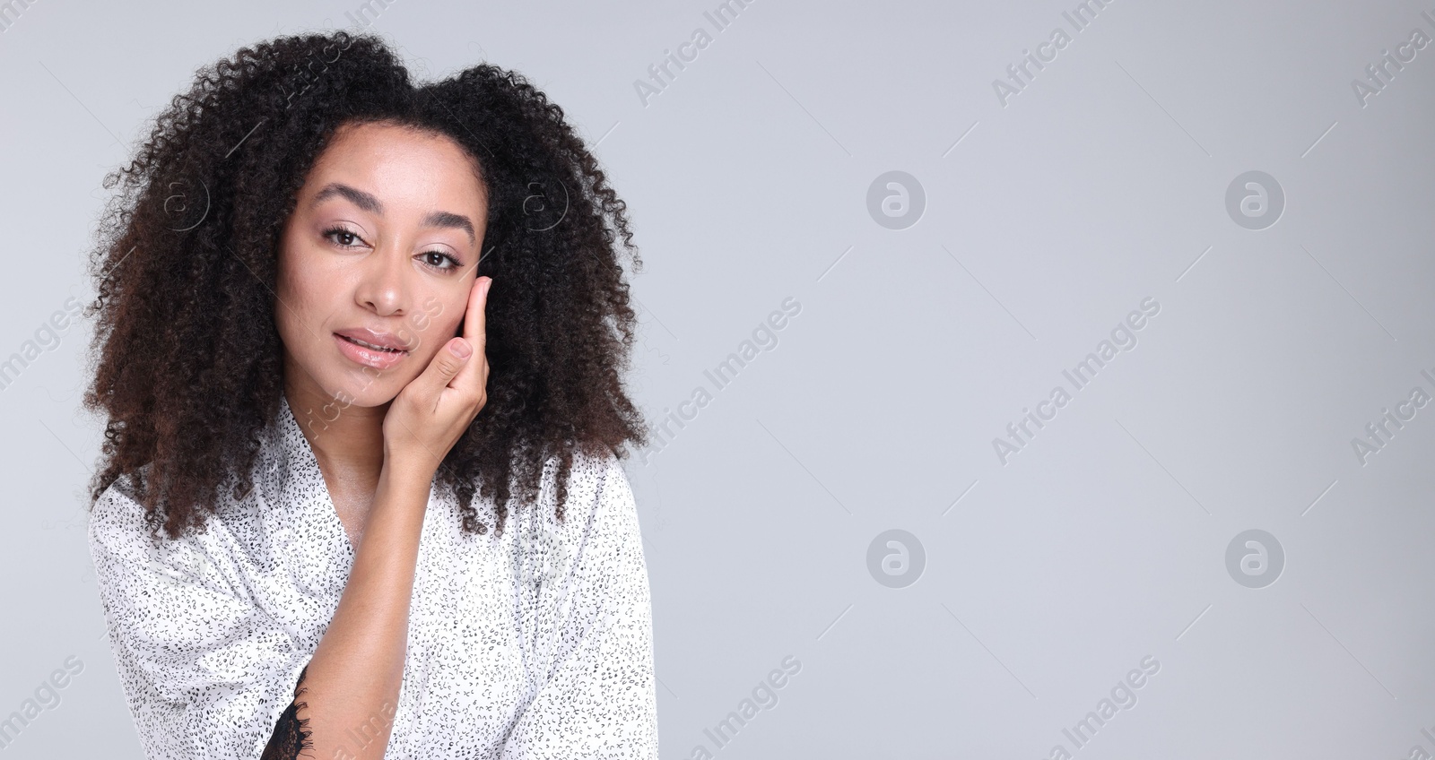 Beautiful Brazilian woman with healthy skin on gray background. Space for text Photo of Beautiful Brazilian woman with healthy skin on gray background. Space for text
