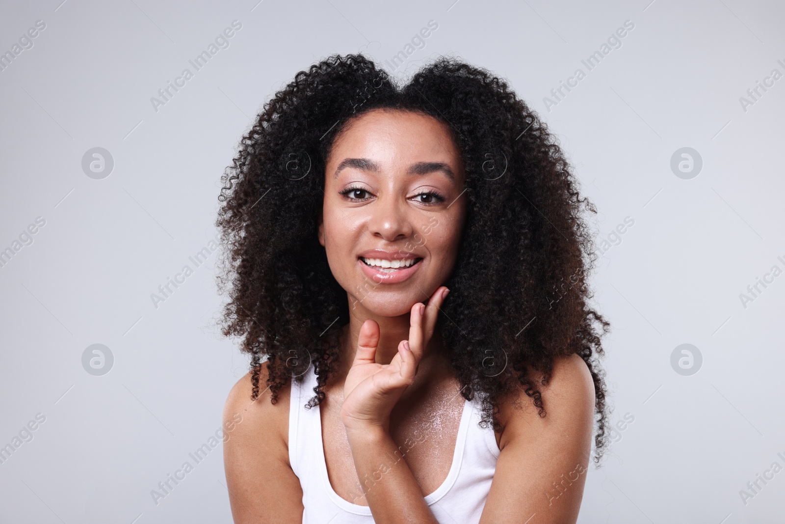 Beautiful Brazilian woman with healthy skin on gray background Photo of Beautiful Brazilian woman with healthy skin on gray background
