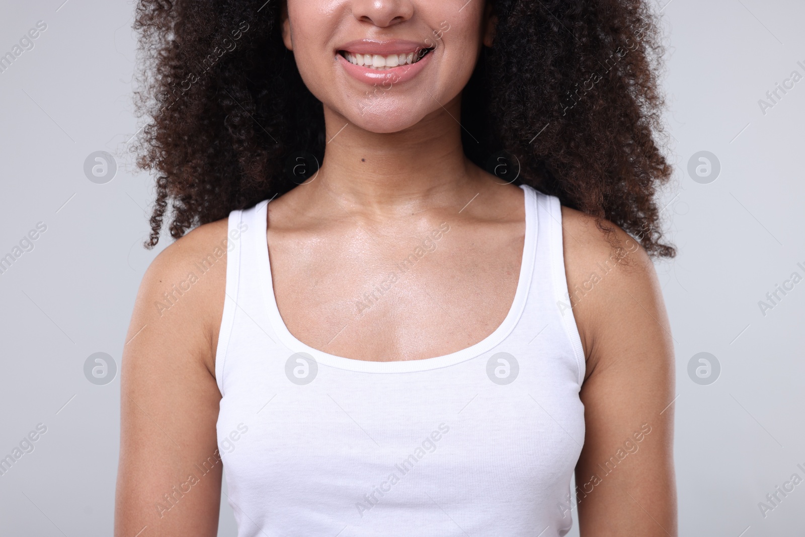 Brazilian woman with healthy skin on gray background, closeup Photo of Brazilian woman with healthy skin on gray background, closeup