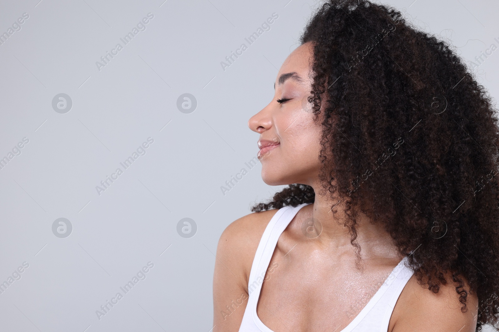 Beautiful Brazilian woman with healthy skin on gray background. Space for text Photo of Beautiful Brazilian woman with healthy skin on gray background. Space for text