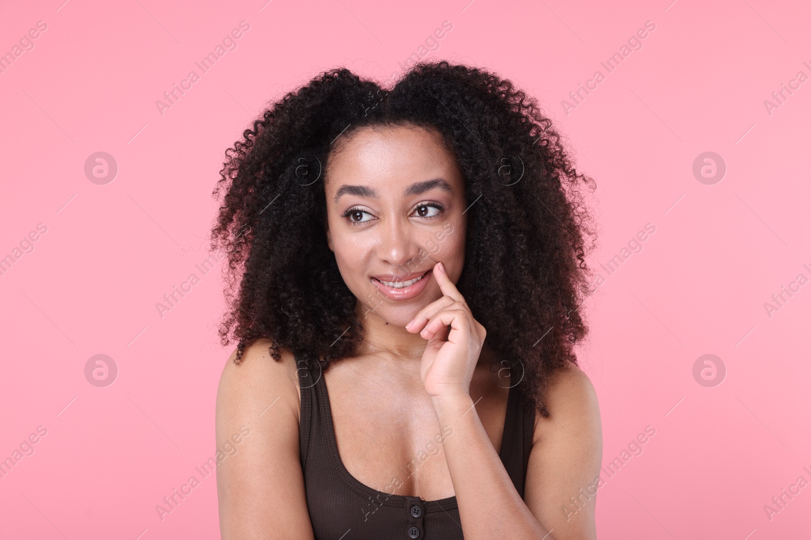 Beautiful Brazilian woman with healthy skin on pink background Photo of Beautiful Brazilian woman with healthy skin on pink background