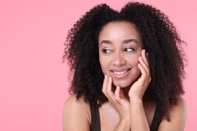 Photo of Beautiful Brazilian woman with healthy skin on pink background. Space for text