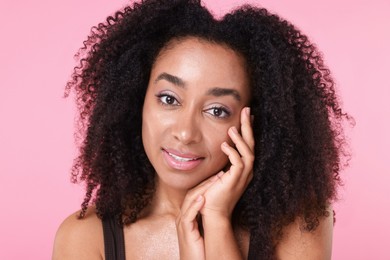 Photo of Beautiful Brazilian woman with healthy skin on pink background, closeup