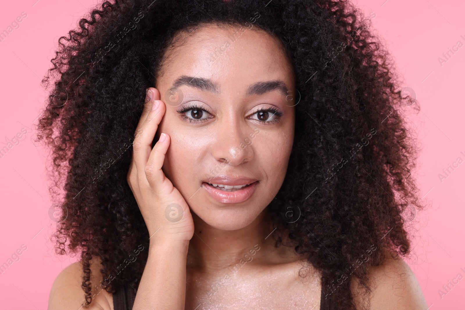 Beautiful Brazilian woman with healthy skin on pink background, closeup Photo of Beautiful Brazilian woman with healthy skin on pink background, closeup