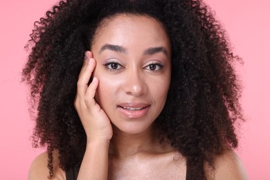 Photo of Beautiful Brazilian woman with healthy skin on pink background, closeup