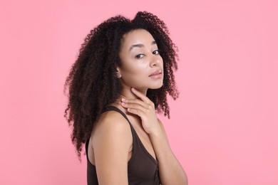 Photo of Beautiful Brazilian woman with healthy skin on pink background