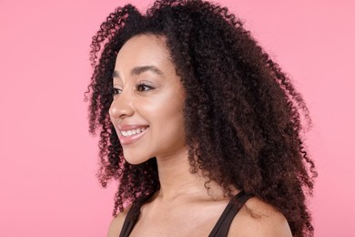 Photo of Beautiful Brazilian woman with healthy skin on pink background