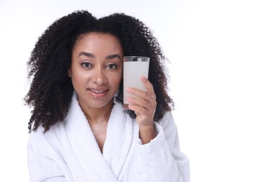 Photo of Beautiful Brazilian woman with glass of collagen water on white background