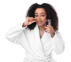 Photo of Beautiful Brazilian woman with glass of water and collagen pill on white background