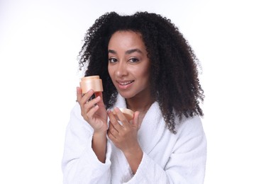 Photo of Beautiful Brazilian woman with jar of collagen cream on white background