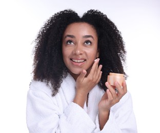 Photo of Beautiful Brazilian woman with jar of collagen cream on white background
