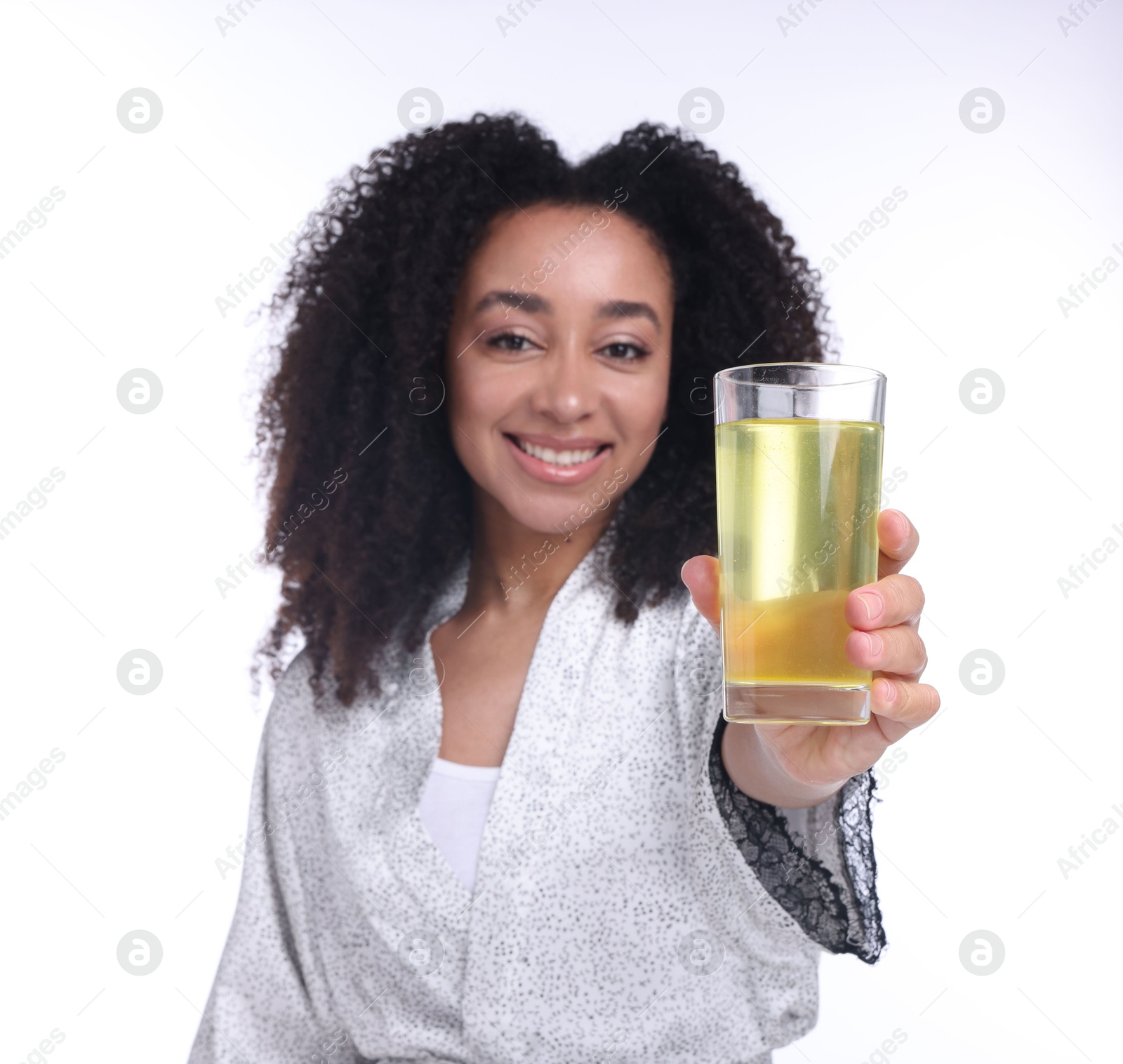 Beautiful Brazilian woman with glass of collagen water on white background, selective focus Photo of Beautiful Brazilian woman with glass of collagen water on white background, selective focus