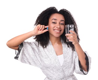 Photo of Beautiful Brazilian woman with glass of water and collagen pill on white background