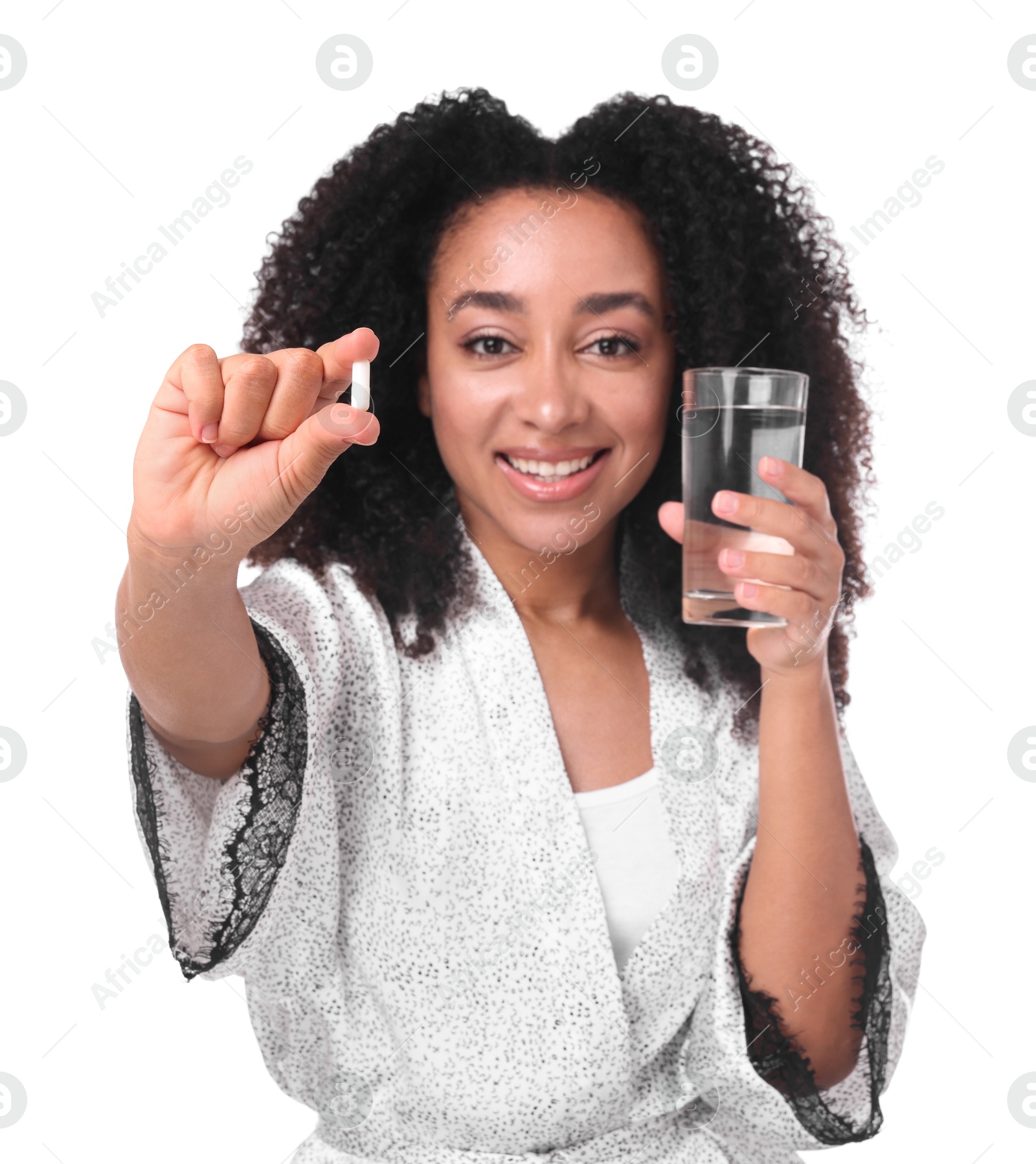 Beautiful Brazilian woman with glass of water and collagen pill on white background, selective focus Photo of Beautiful Brazilian woman with glass of water and collagen pill on white background, selective focus