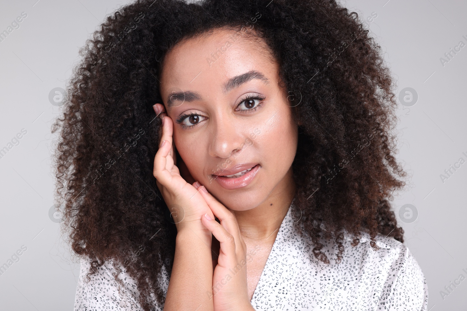 Beautiful Brazilian woman with healthy skin on gray background, closeup Photo of Beautiful Brazilian woman with healthy skin on gray background, closeup