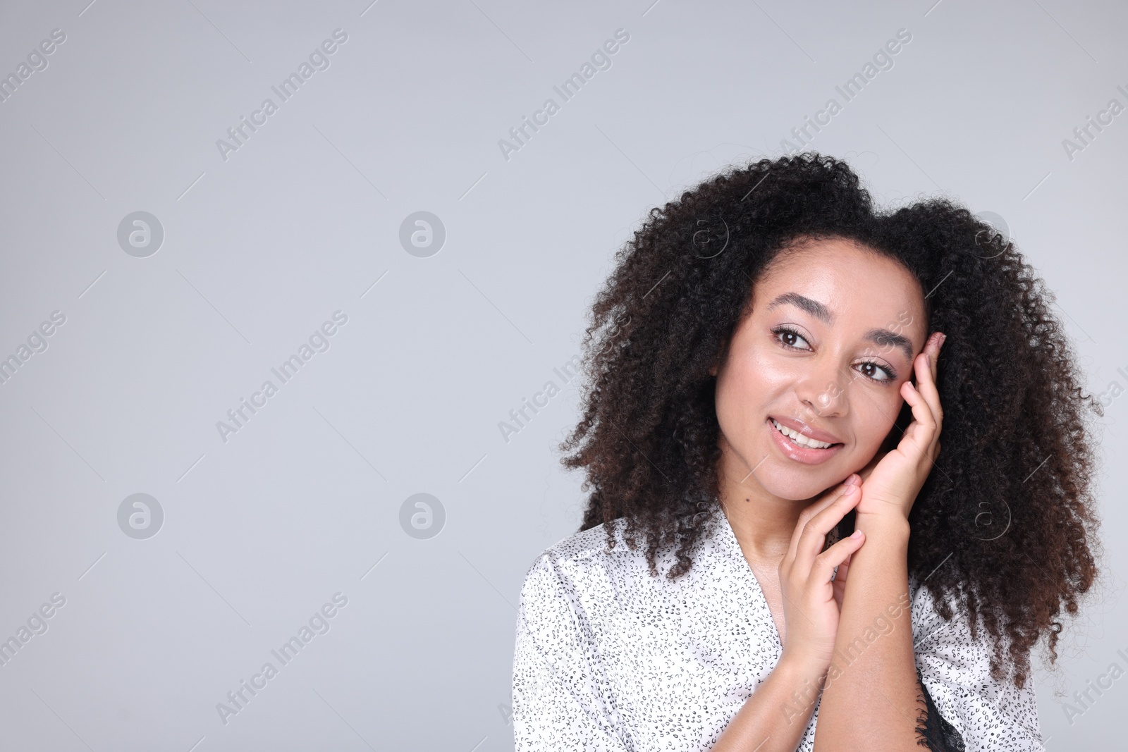 Beautiful Brazilian woman with healthy skin on gray background. Space for text Photo of Beautiful Brazilian woman with healthy skin on gray background. Space for text