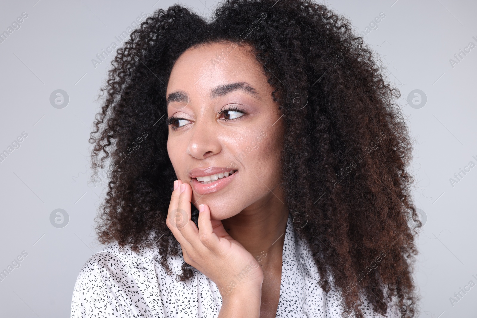 Beautiful Brazilian woman with healthy skin on gray background Photo of Beautiful Brazilian woman with healthy skin on gray background