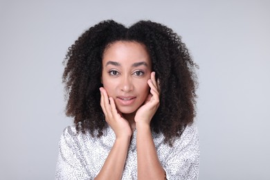 Photo of Beautiful Brazilian woman with healthy skin on gray background