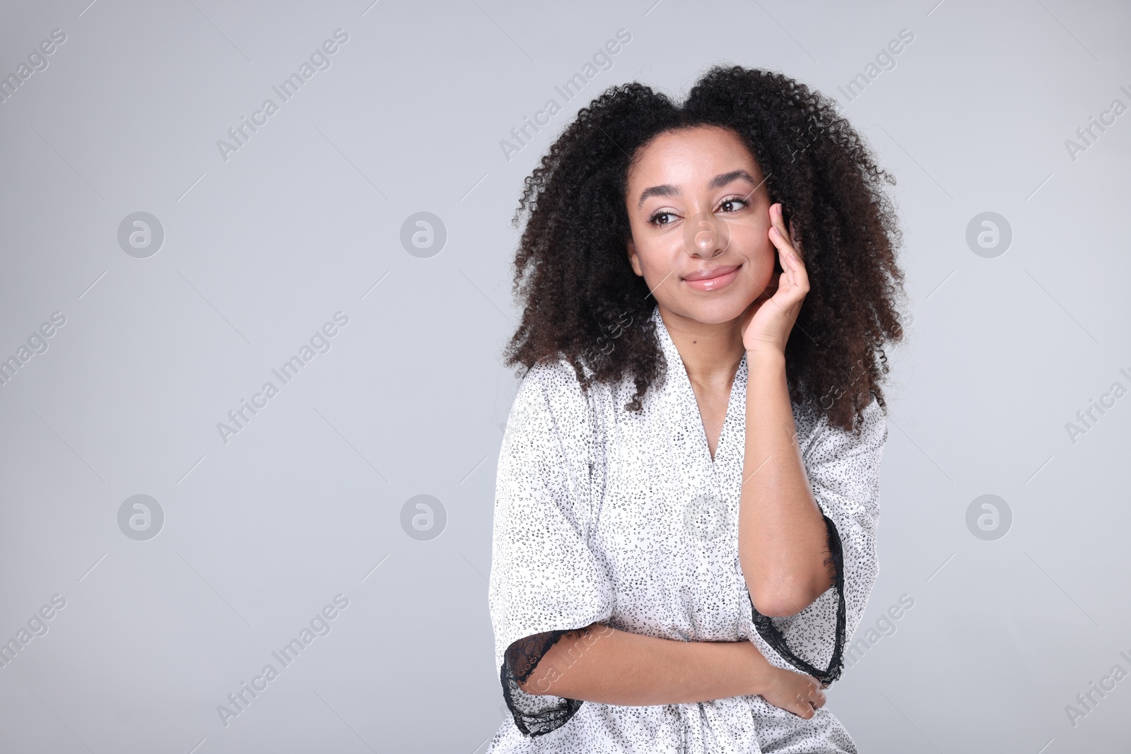 Beautiful Brazilian woman with healthy skin on gray background. Space for text Photo of Beautiful Brazilian woman with healthy skin on gray background. Space for text