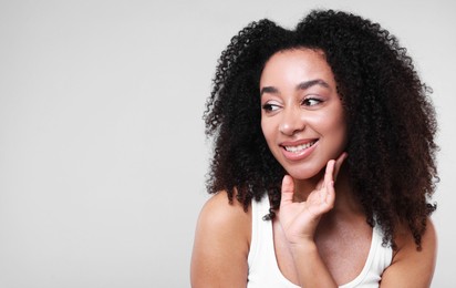 Photo of Beautiful Brazilian woman with healthy skin on gray background. Space for text