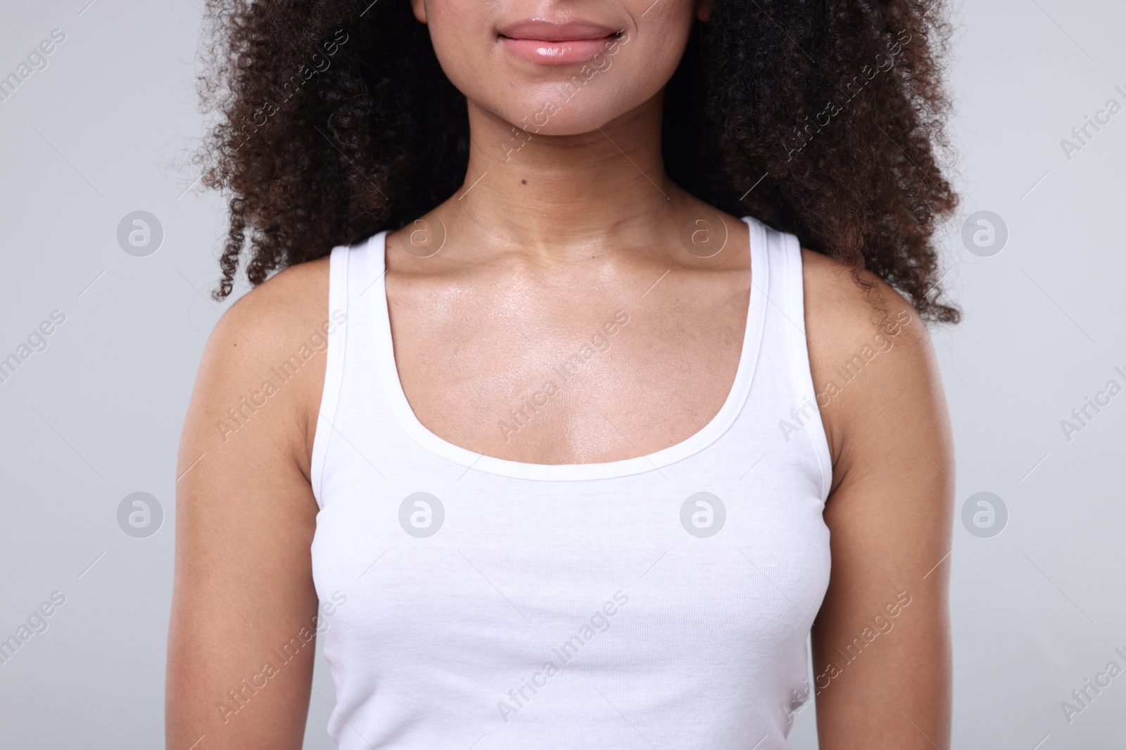 Brazilian woman with healthy skin on gray background, closeup Photo of Brazilian woman with healthy skin on gray background, closeup