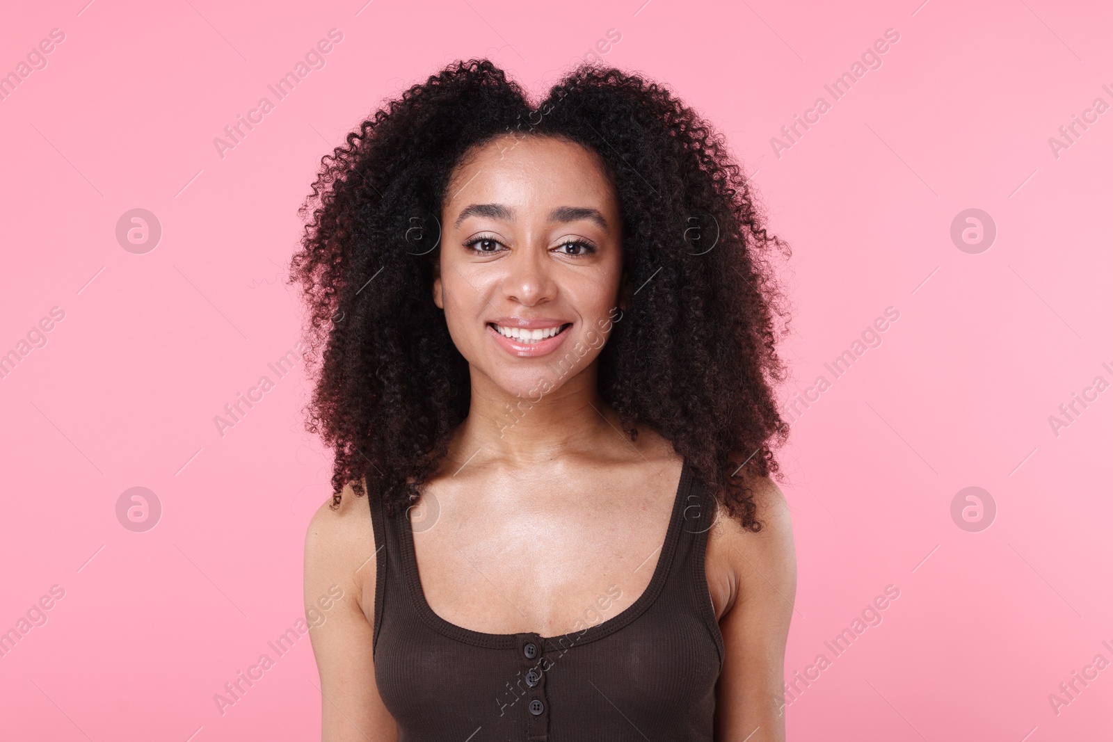 Beautiful Brazilian woman with healthy skin on pink background Photo of Beautiful Brazilian woman with healthy skin on pink background