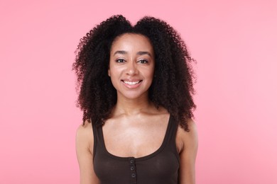 Photo of Beautiful Brazilian woman with healthy skin on pink background