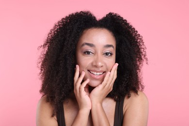 Photo of Beautiful Brazilian woman with healthy skin on pink background