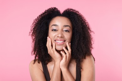 Photo of Beautiful Brazilian woman with healthy skin on pink background