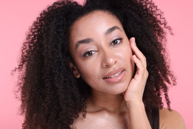 Photo of Beautiful Brazilian woman with healthy skin on pink background, closeup