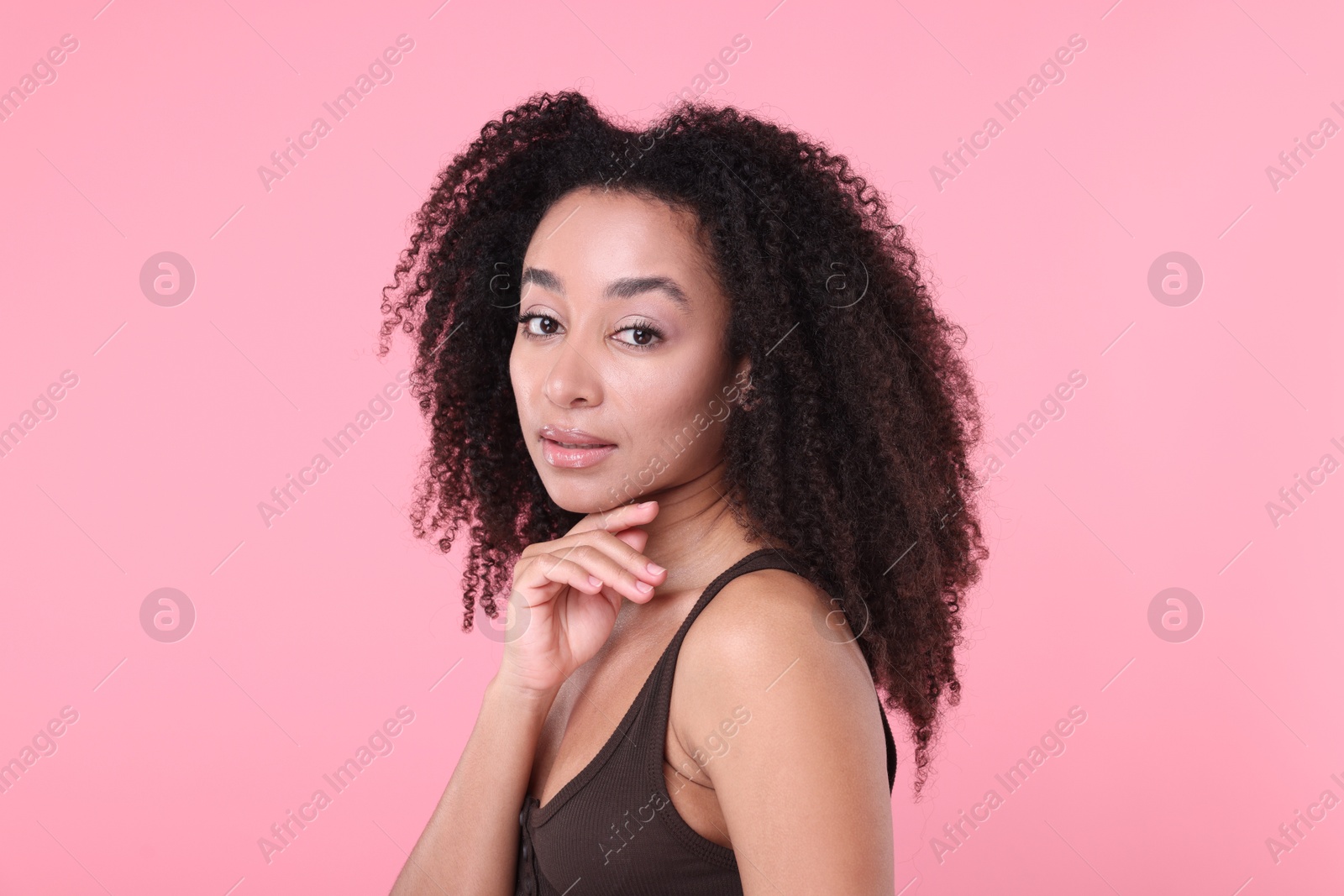 Beautiful Brazilian woman with healthy skin on pink background Photo of Beautiful Brazilian woman with healthy skin on pink background