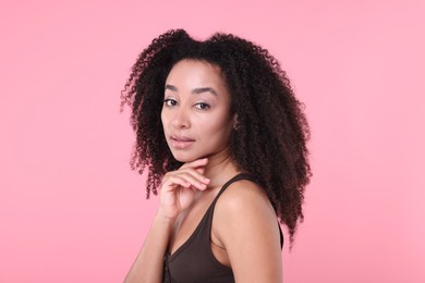 Photo of Beautiful Brazilian woman with healthy skin on pink background