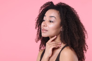 Photo of Beautiful Brazilian woman with healthy skin on pink background. Space for text